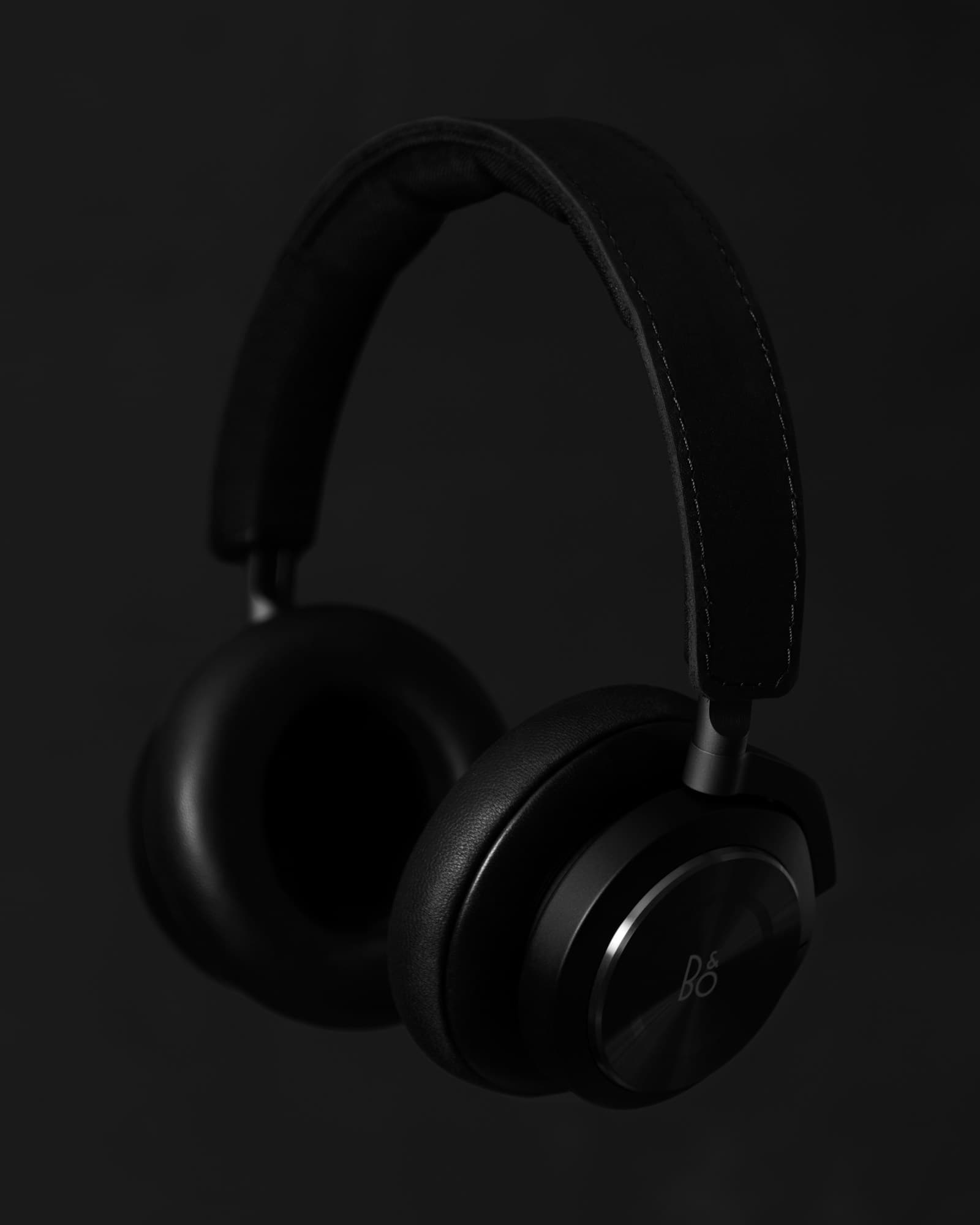 Black over-ear wireless headphones photographed against a dark background